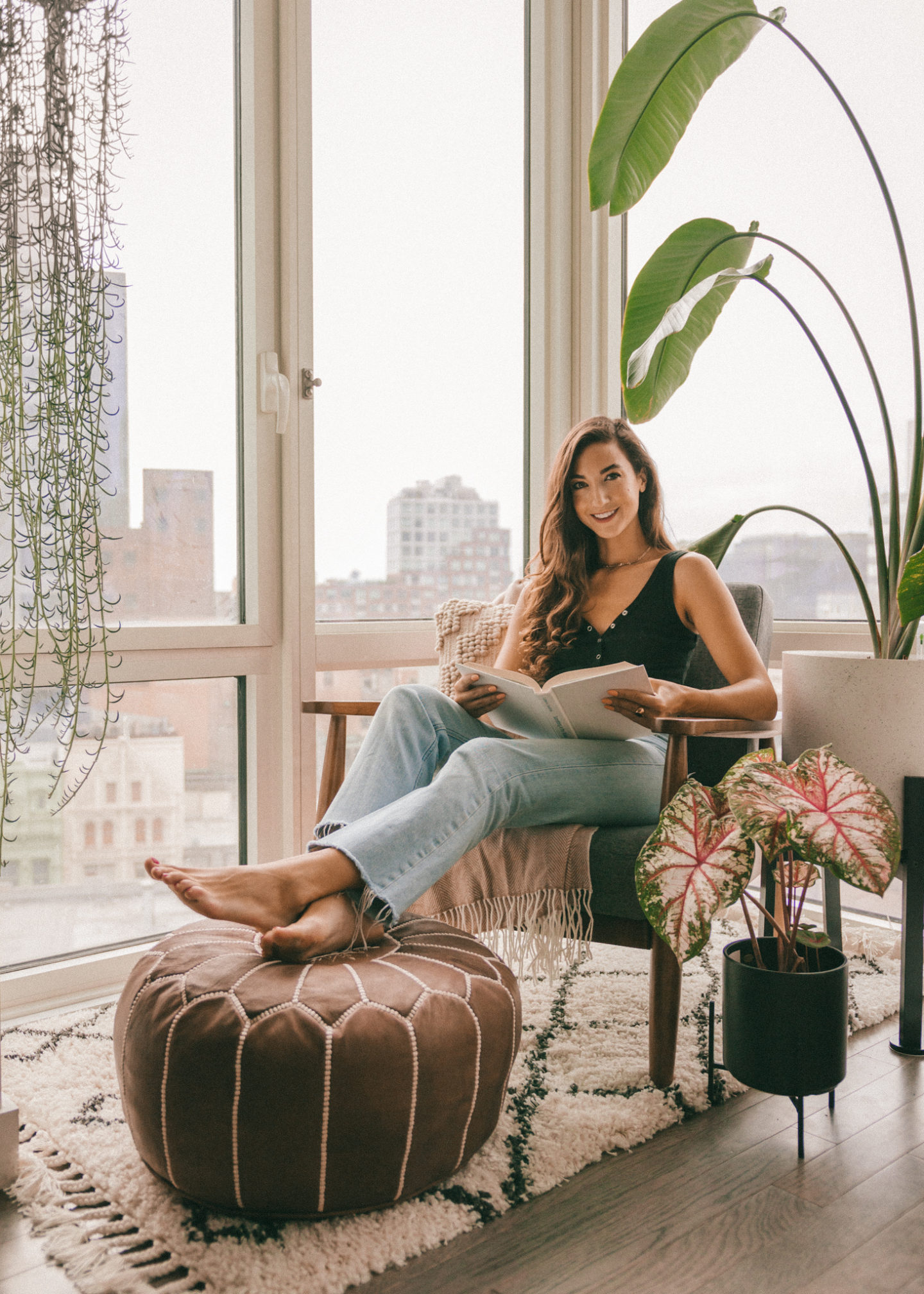 Living room mid-century modern furniture cozy corner nook rug house plants interior decorating home inspo decor NYC Brooklyn Bird of paradise bohemian